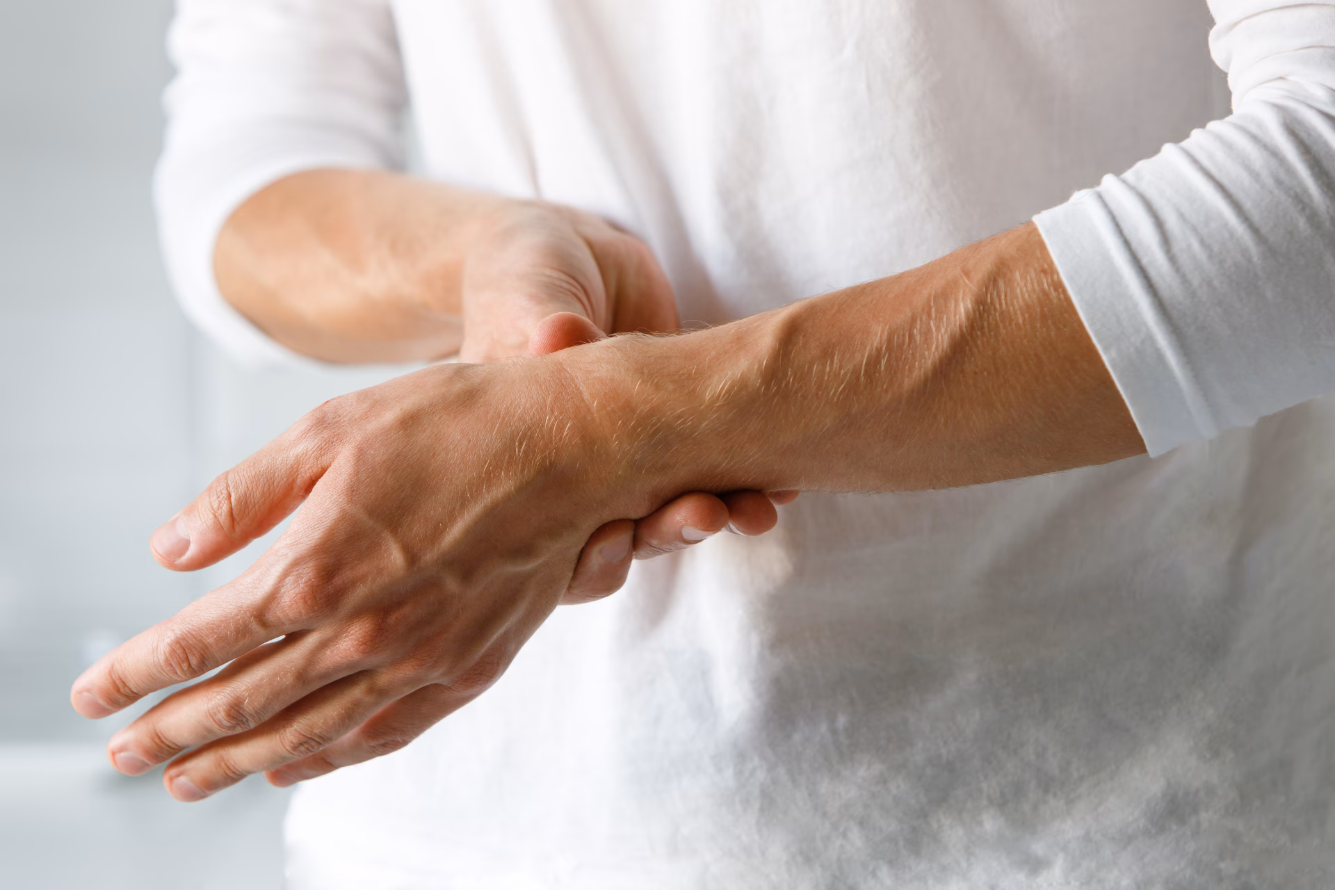 closeup of man arms holding painful wrist caused b 2026 03 19 22 52 01 utc converted