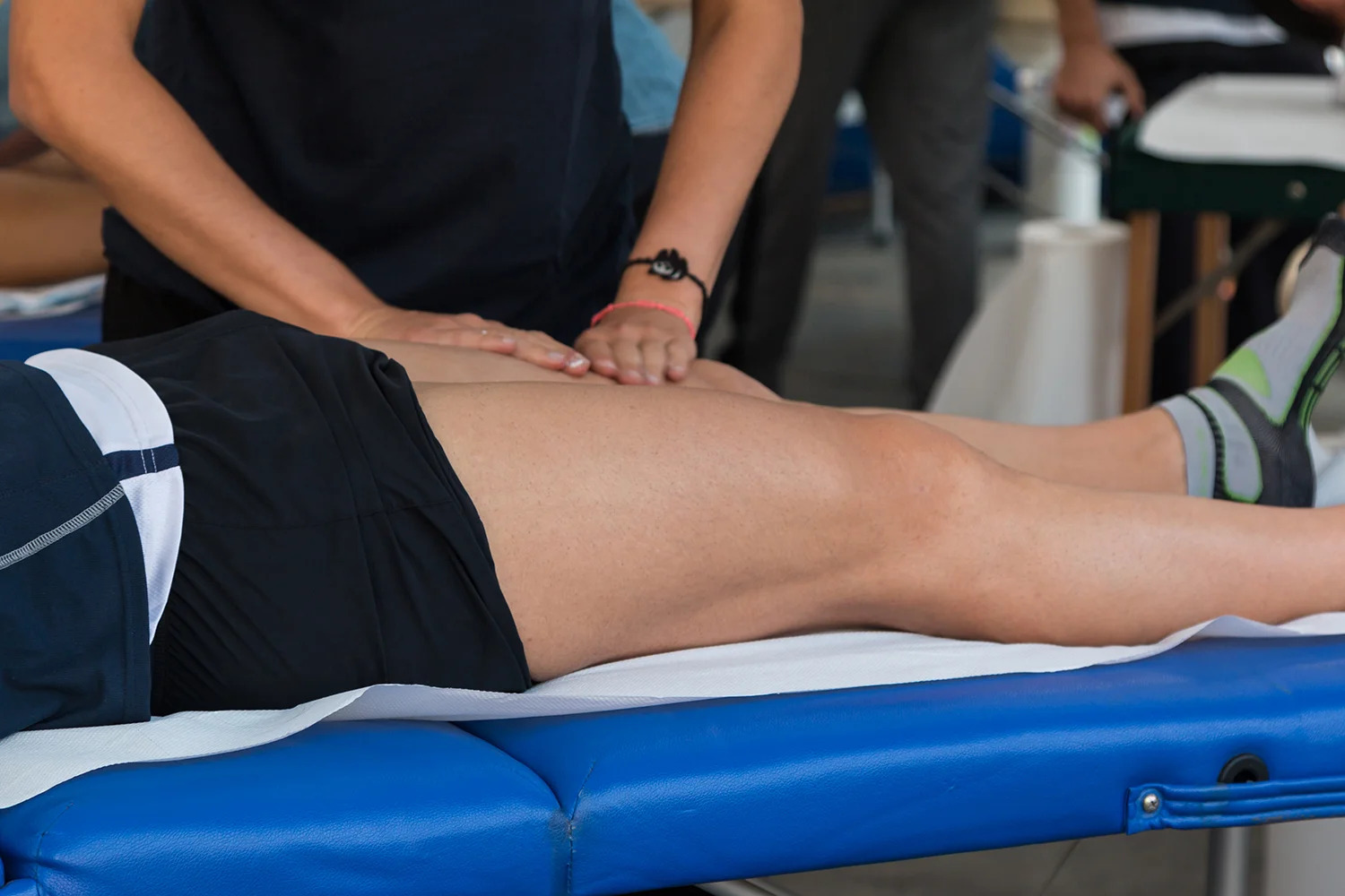 adult receiving massage on thigh