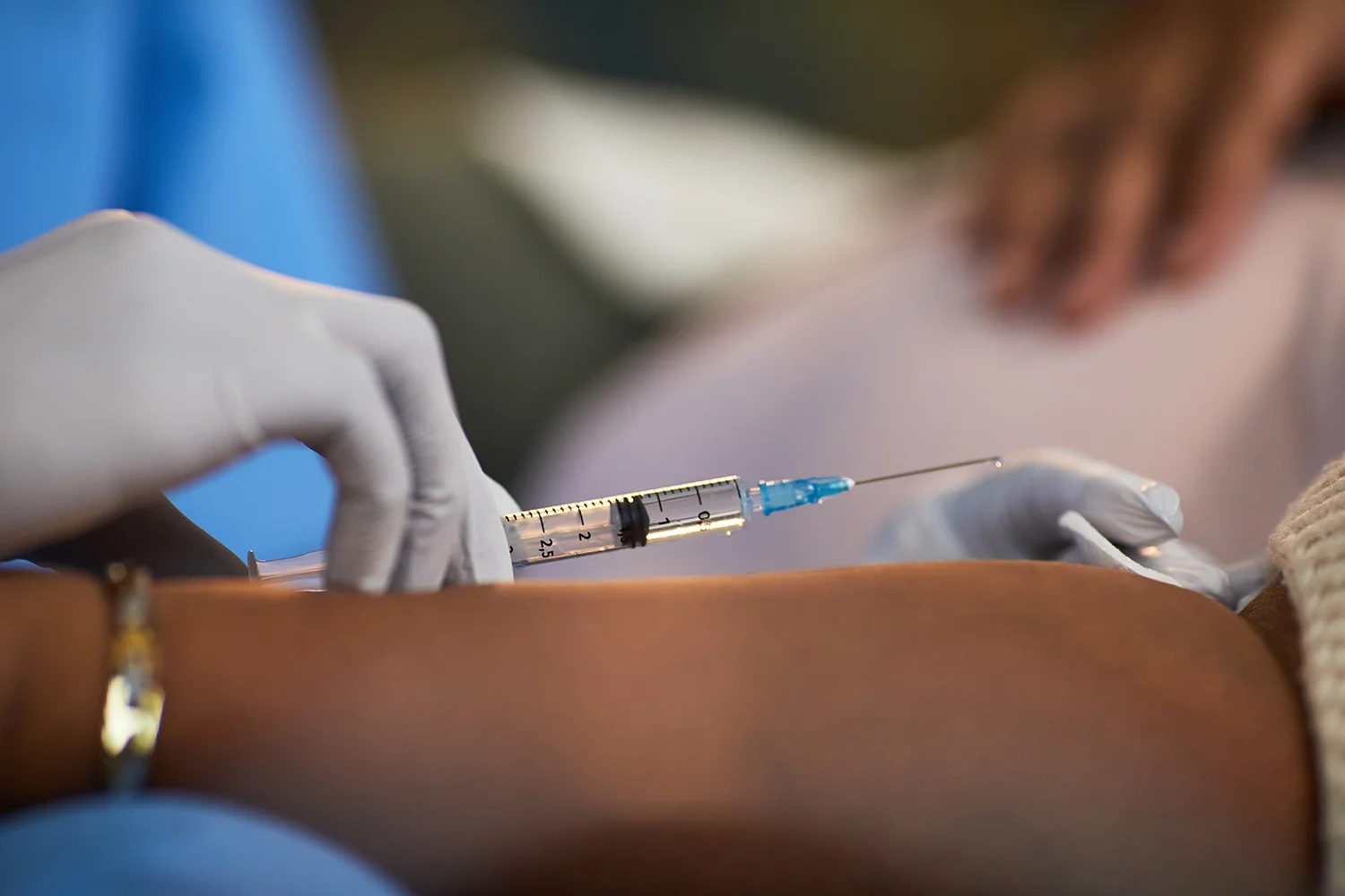 medical professional administers injection