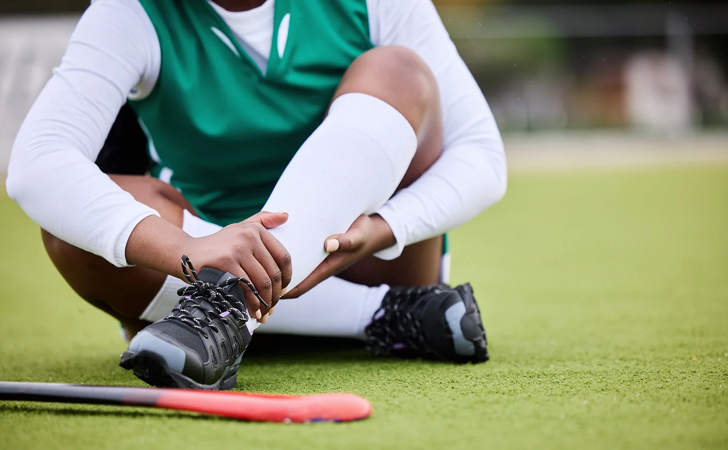 sports pain and leg injury by woman hockey player